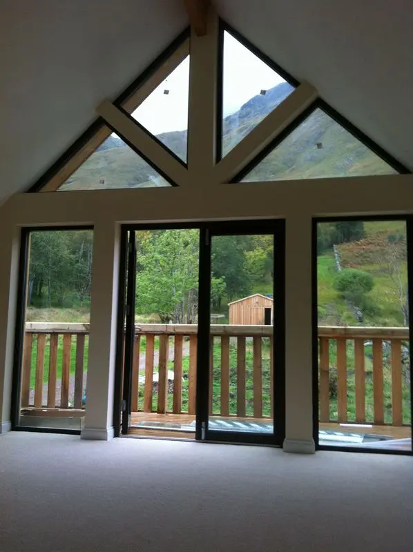 Arnisdale vaulted room with gable glazing opening onto the balcony and hillside