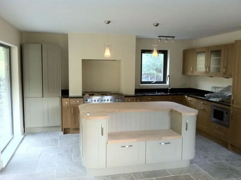 Arnisdale kitchen with central island, range cooker and stone-tiled floor