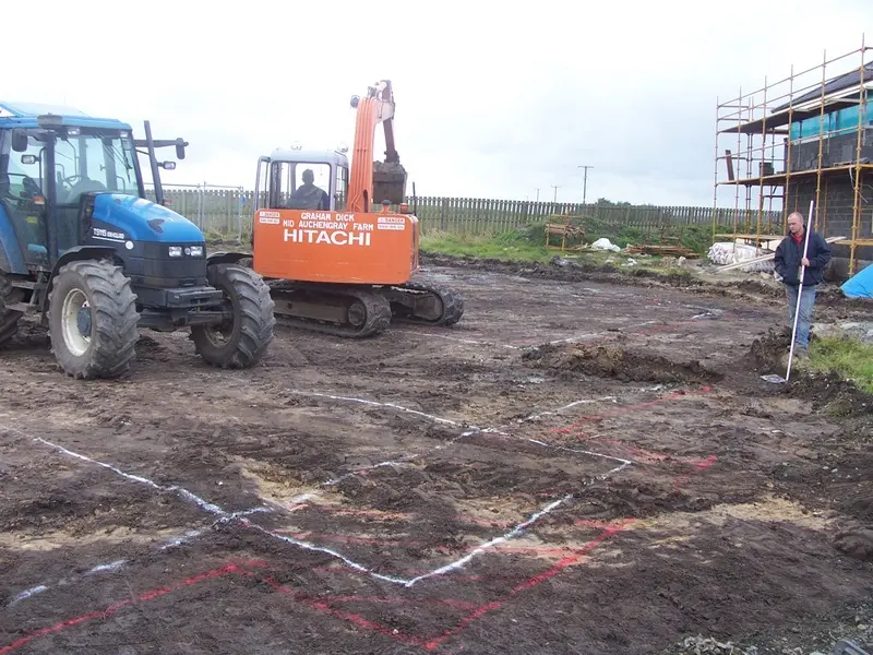 Setting out the plot, with the house footprint marked on the ground