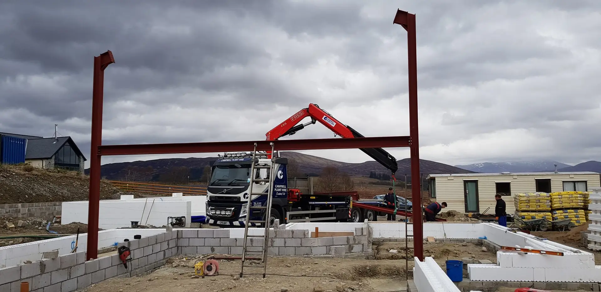 Steel frame being lifted into place by crane