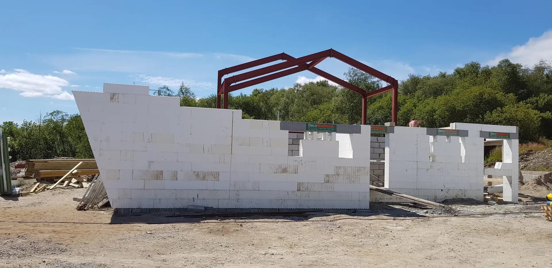 ICF gable wall rising beneath the steel frames