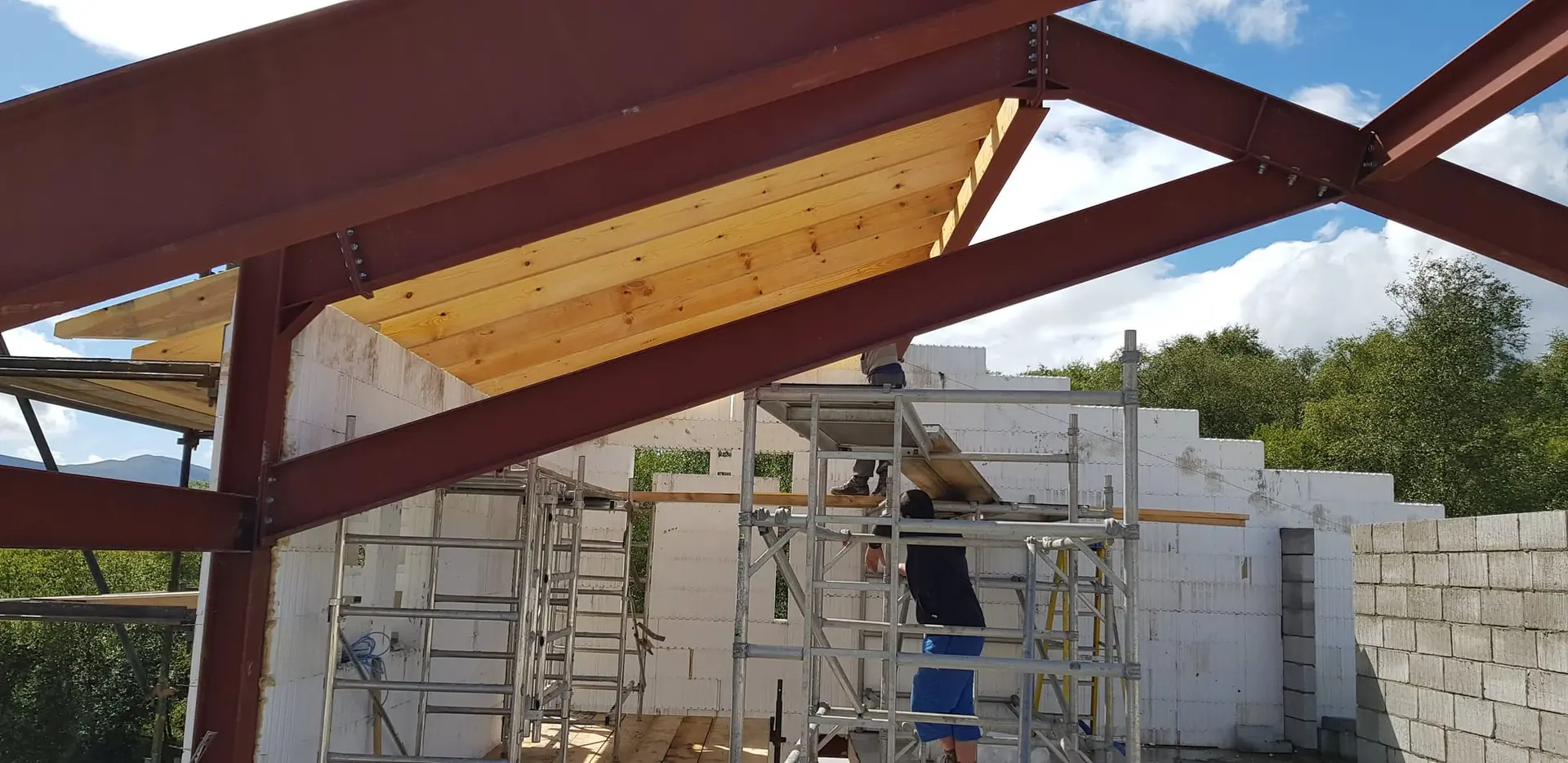 Roof sarking going on over the steel frame