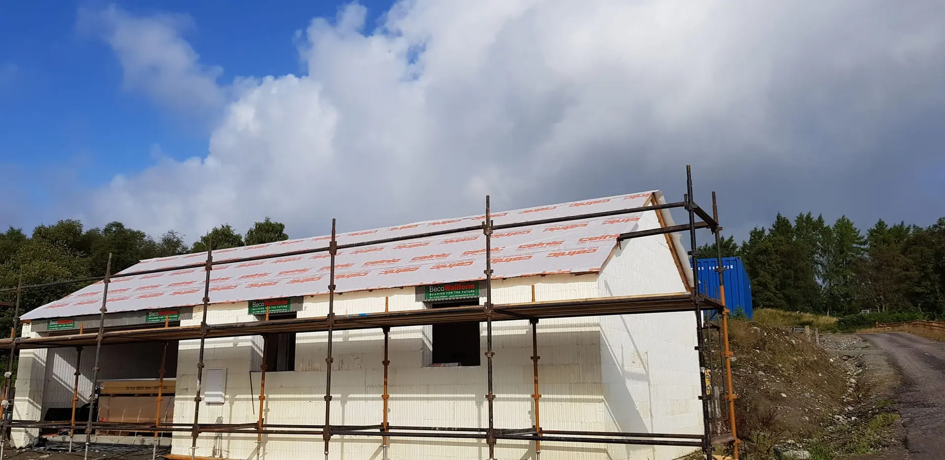 Roof membrane on, with the house under scaffold