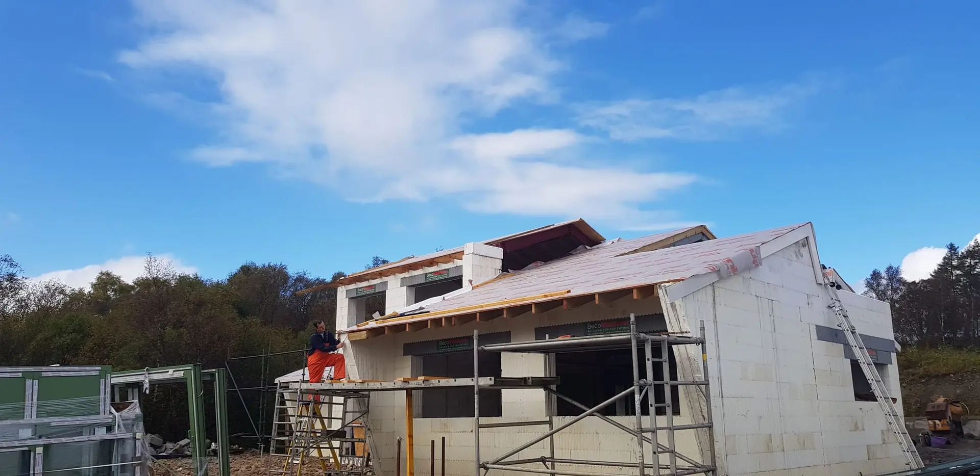 Windows going in and the upper roof being finished