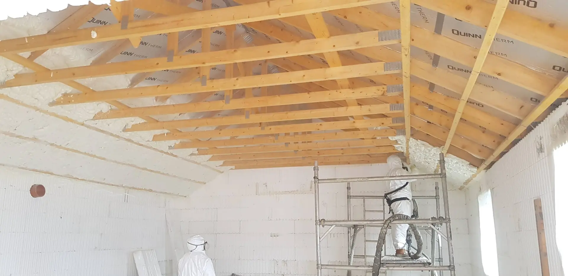 Spray foam insulation being applied to the roof