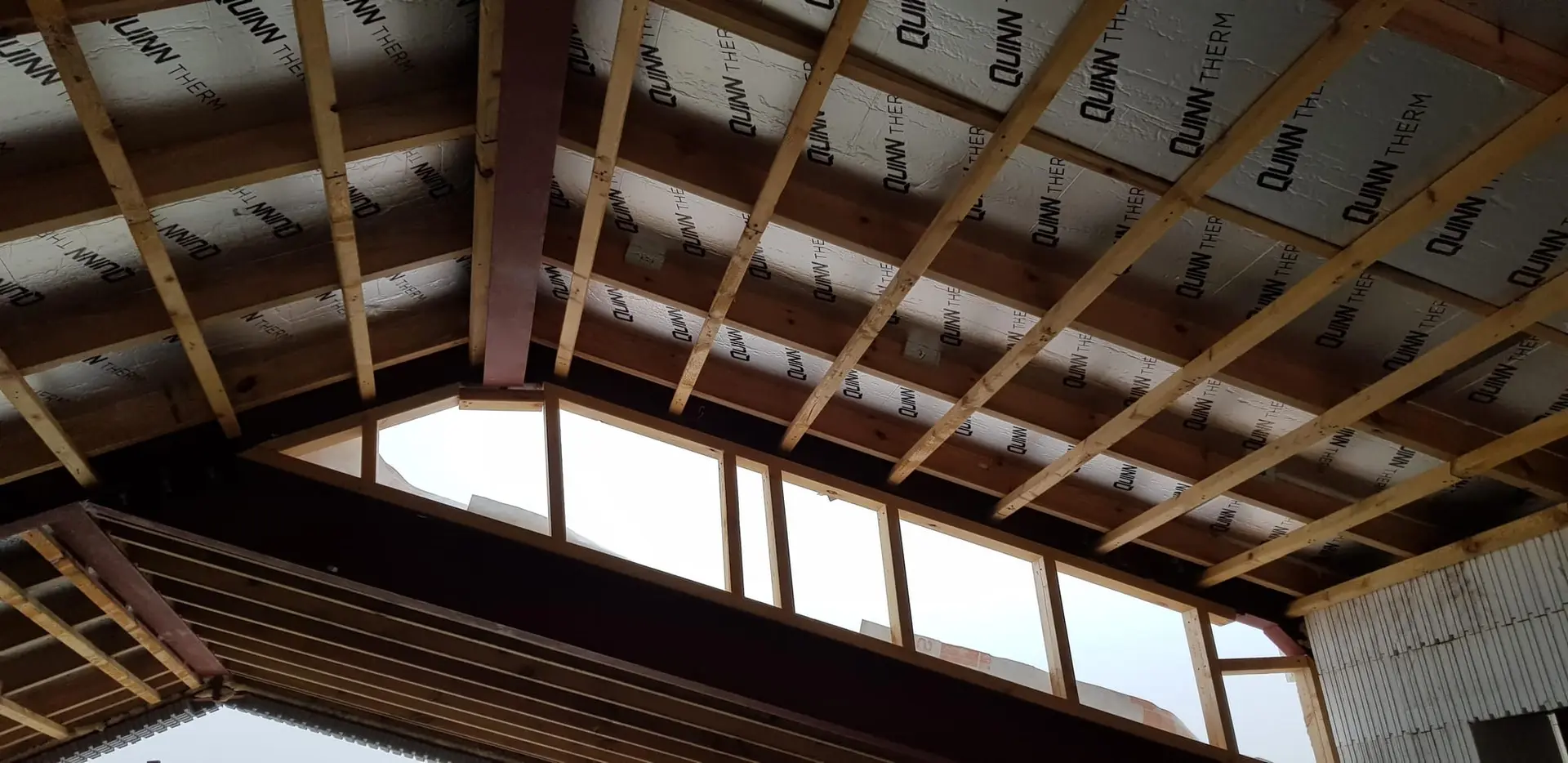 Insulation boards between the rafters above the clerestory glazing
