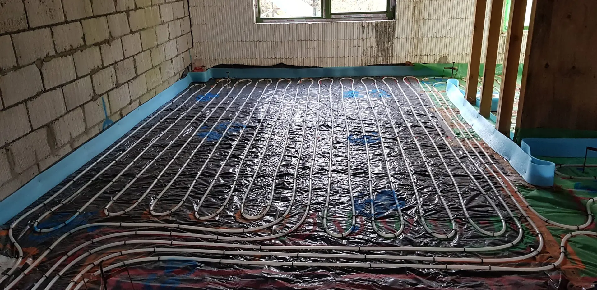 Underfloor heating pipes laid across the ground floor