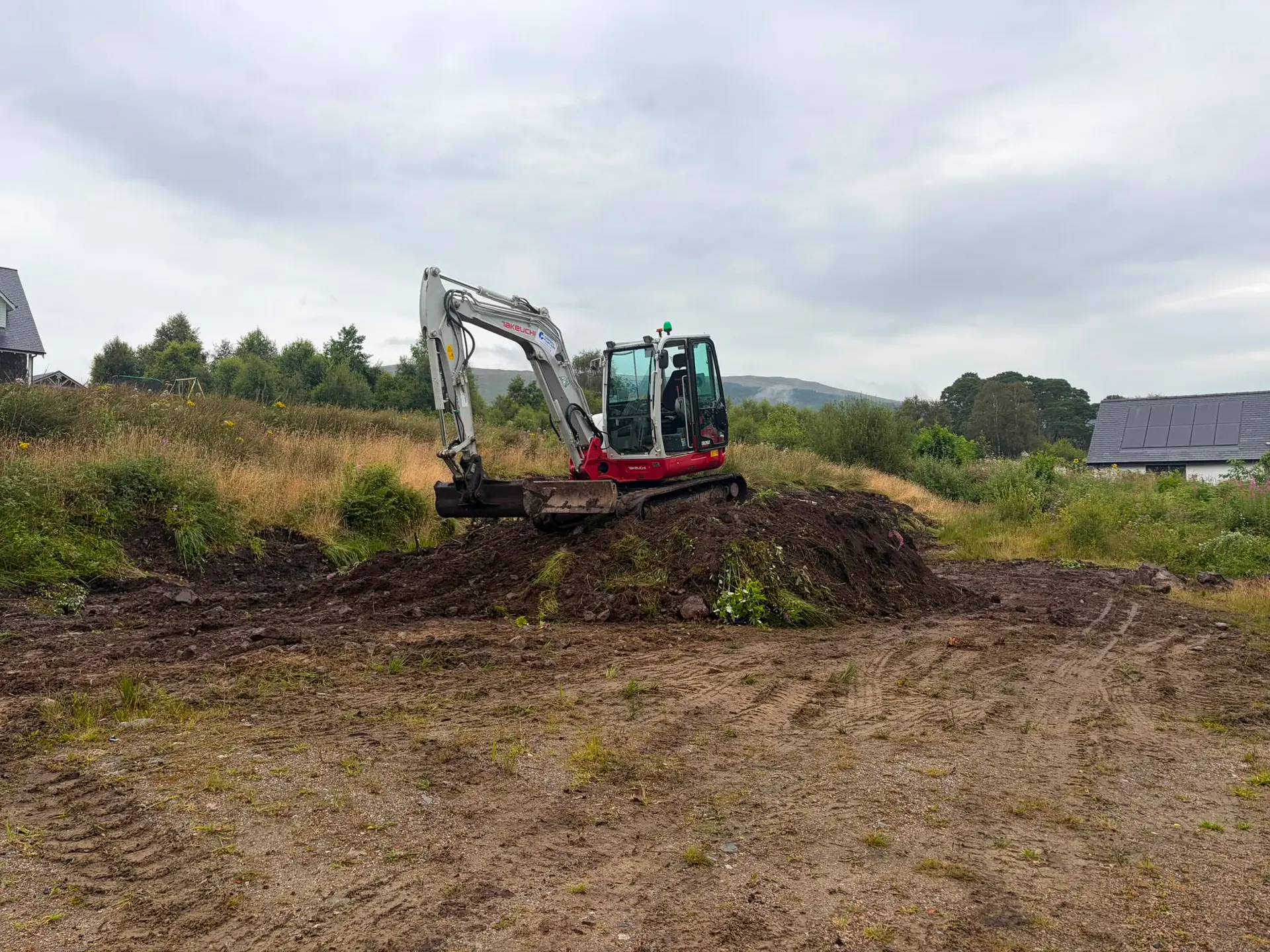 Digger clearing the plot at the start of groundworks