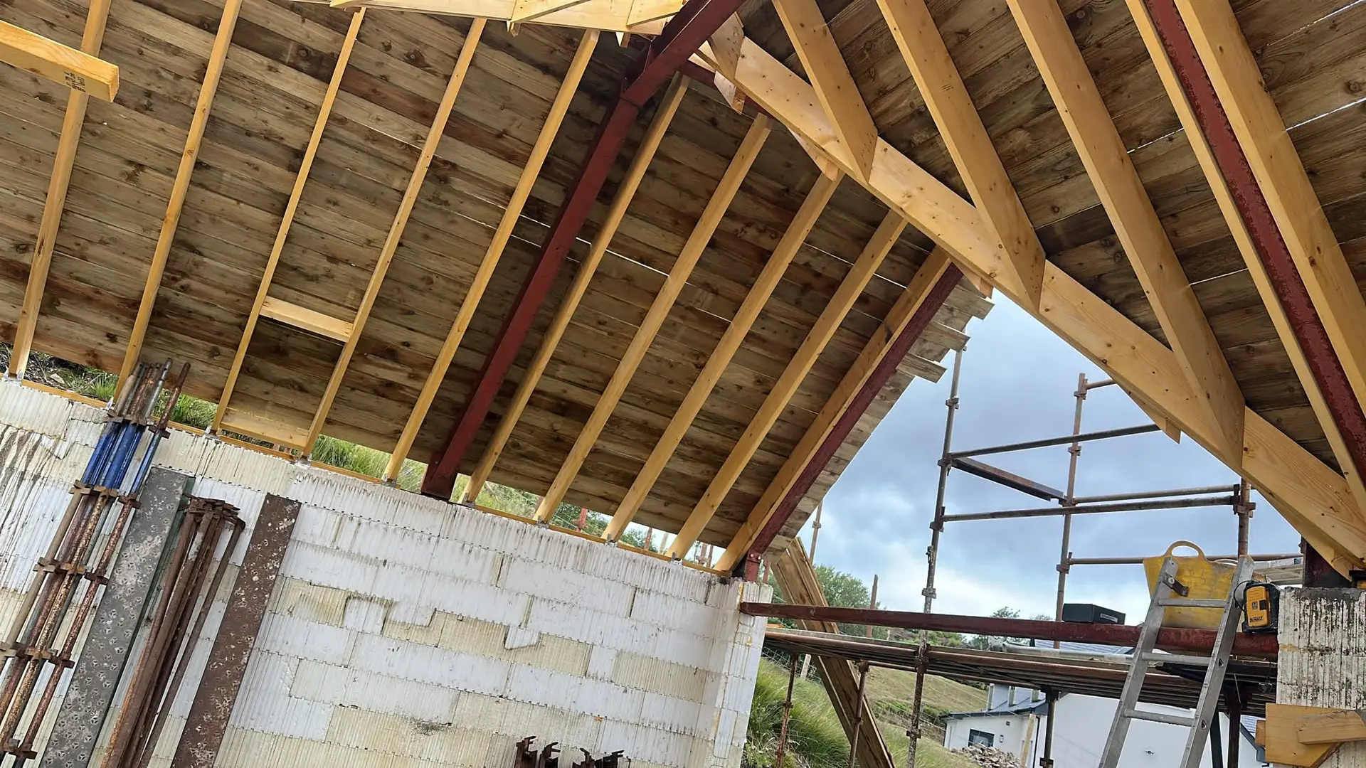 Underside of the boarded roof with the steel frame and gable opening