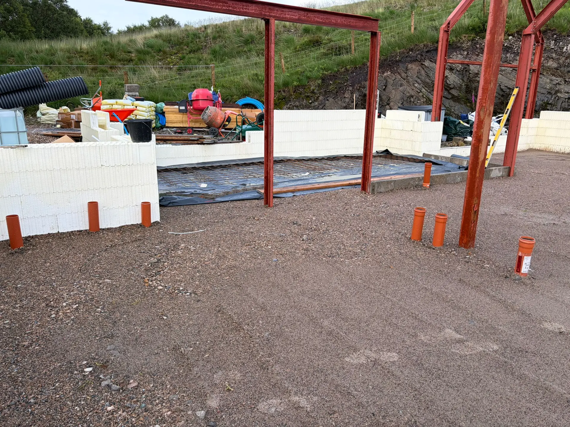 Compacted sub-base with drainage pipes and the first ICF walls