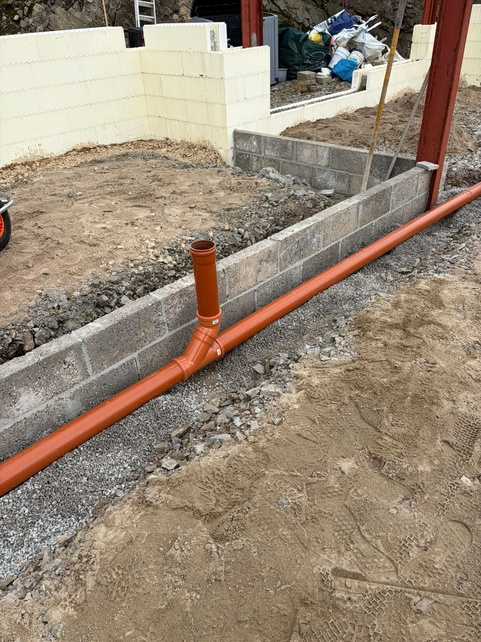 Drainage run along the blockwork with a vertical connection