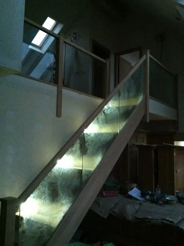 Sasaig oak and glass staircase rising to the galleried landing