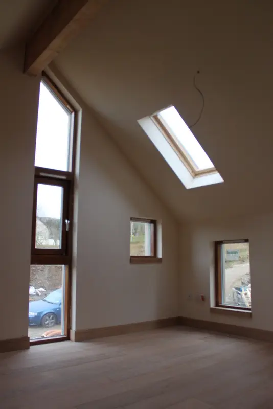 Sasaig vaulted bedroom with full-height window, rooflight and oak floor